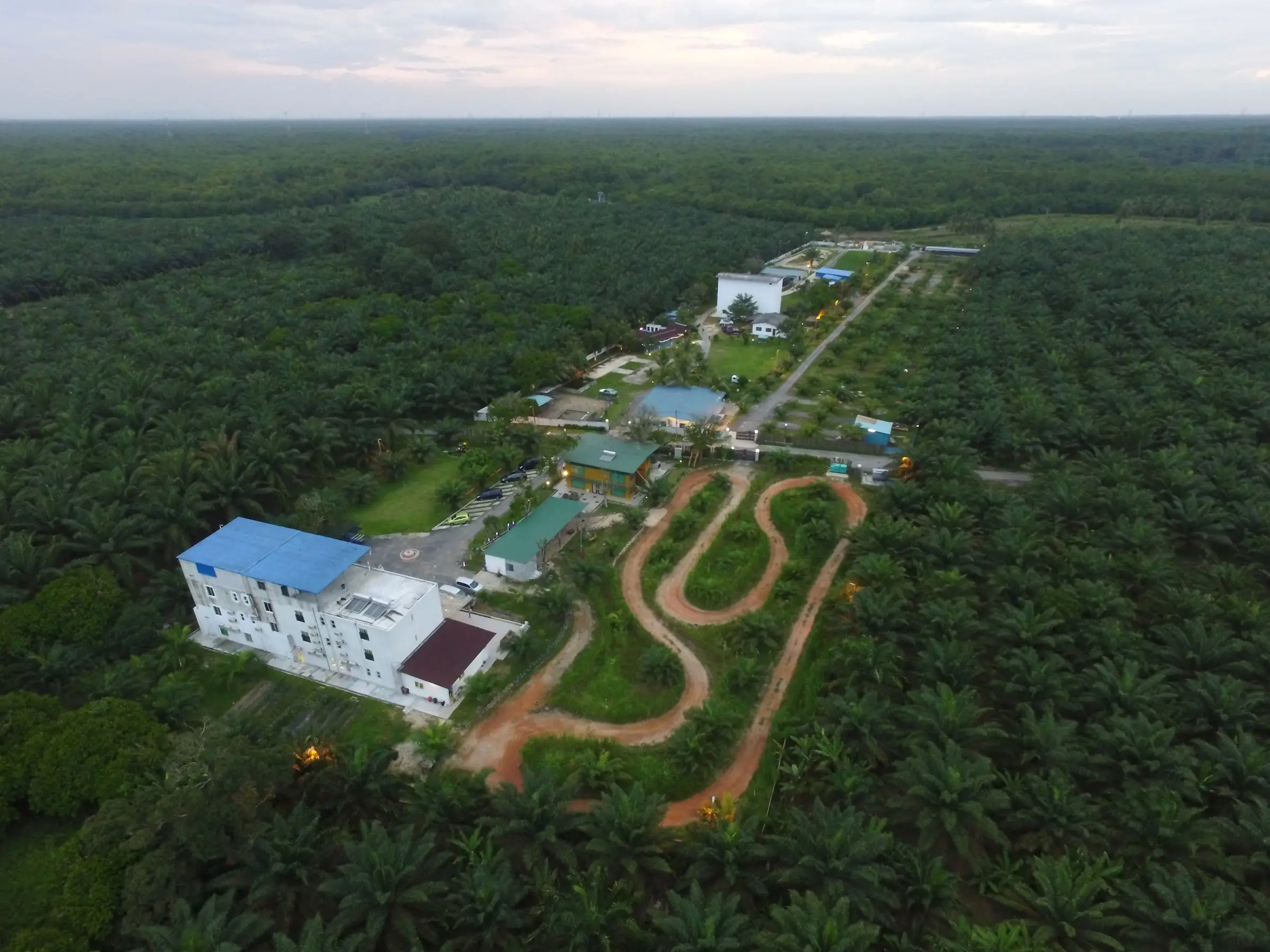 Early aerial view of the resort and ATV track carved out of the surrounding oil palm estate