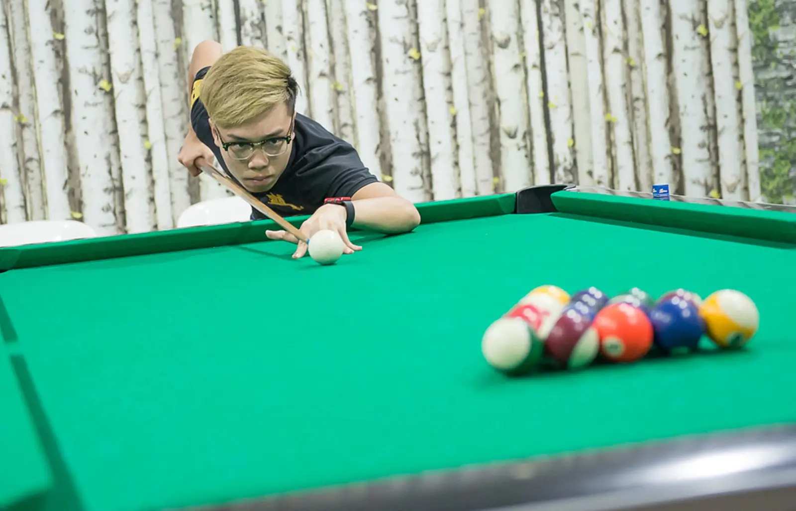 A guest lines up a break shot on the Pool Table in the games room