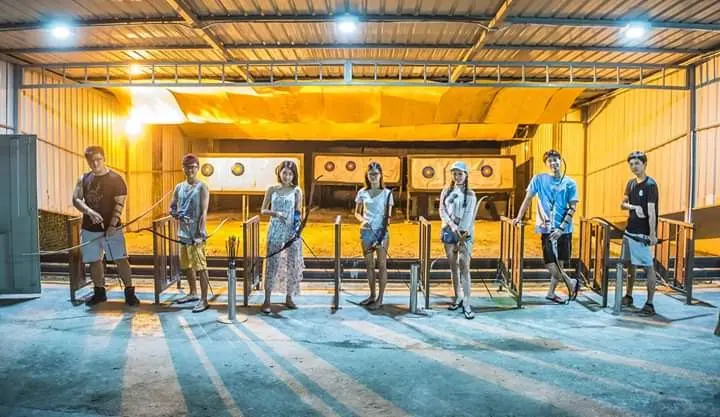 A group lines up at the shooting stations of the covered Archery Range