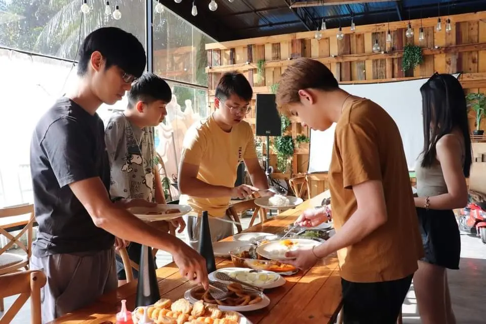 Friends help themselves at the buffet in the wood-panelled cafe