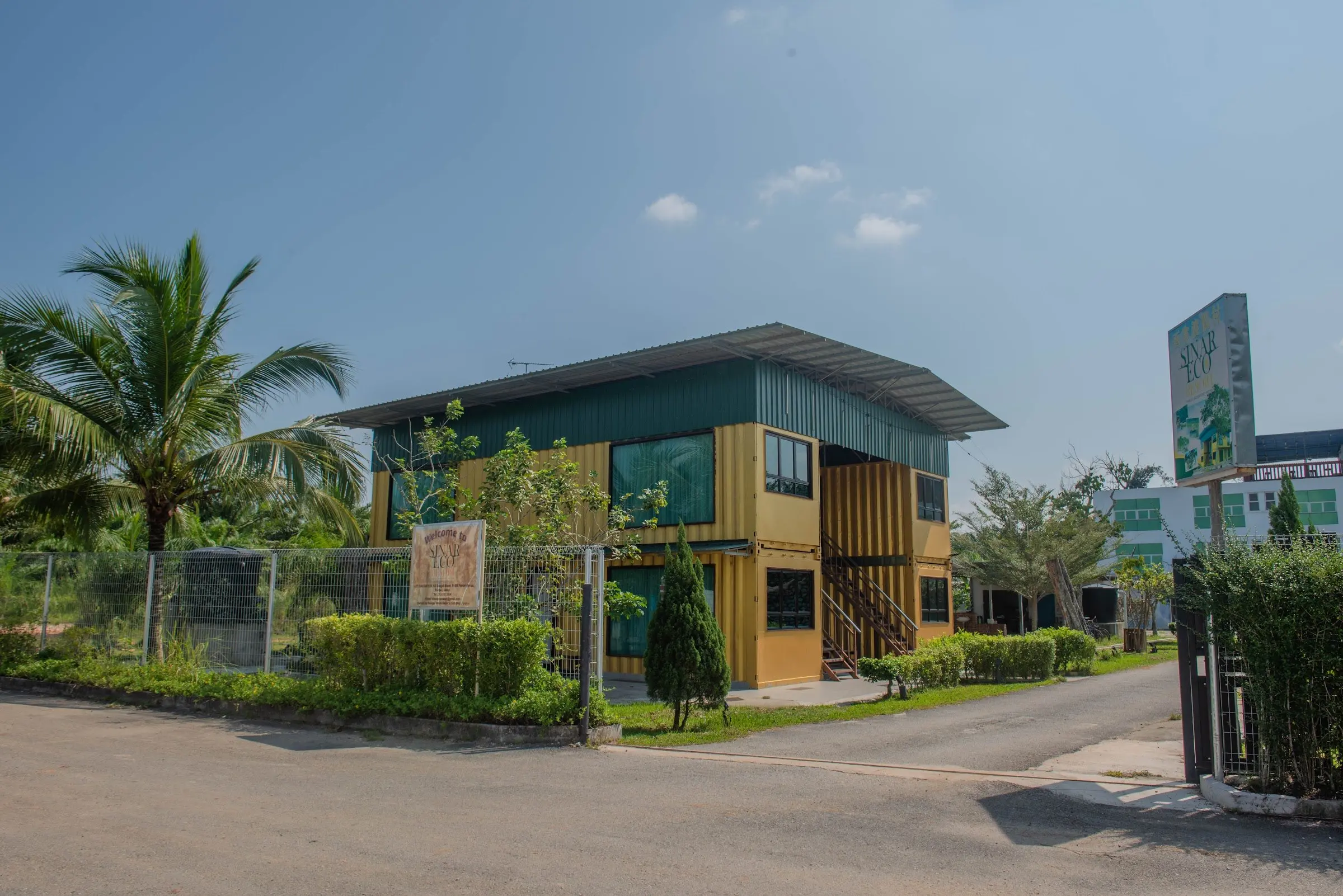 The yellow two-storey Container Room block, with the Family Room building and resort sign beyond