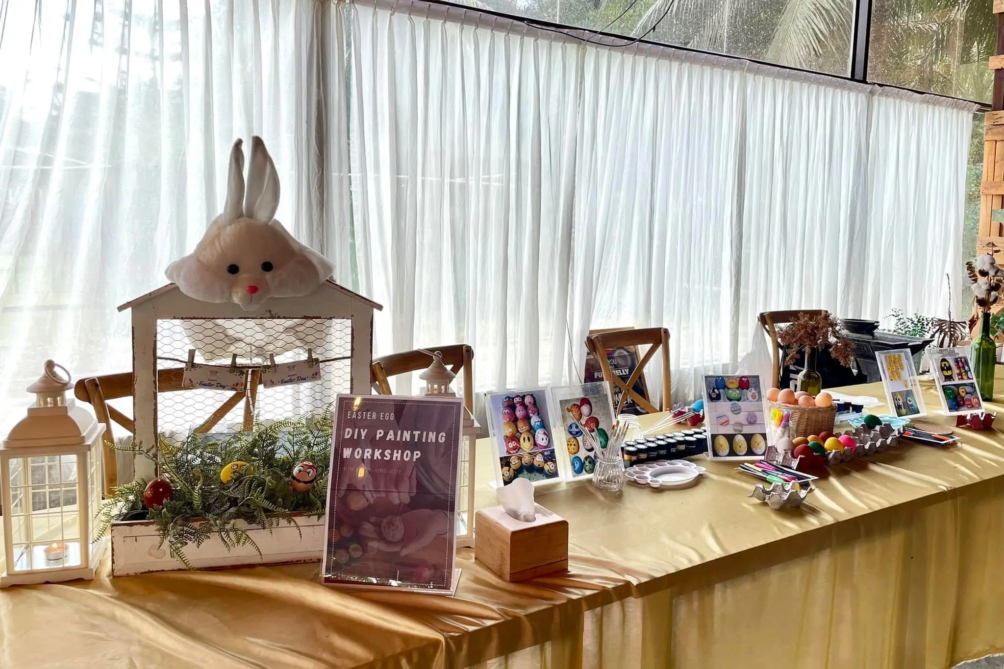 A Special Workshop table laid out for DIY painting, with canvases, paints and a bunny centrepiece