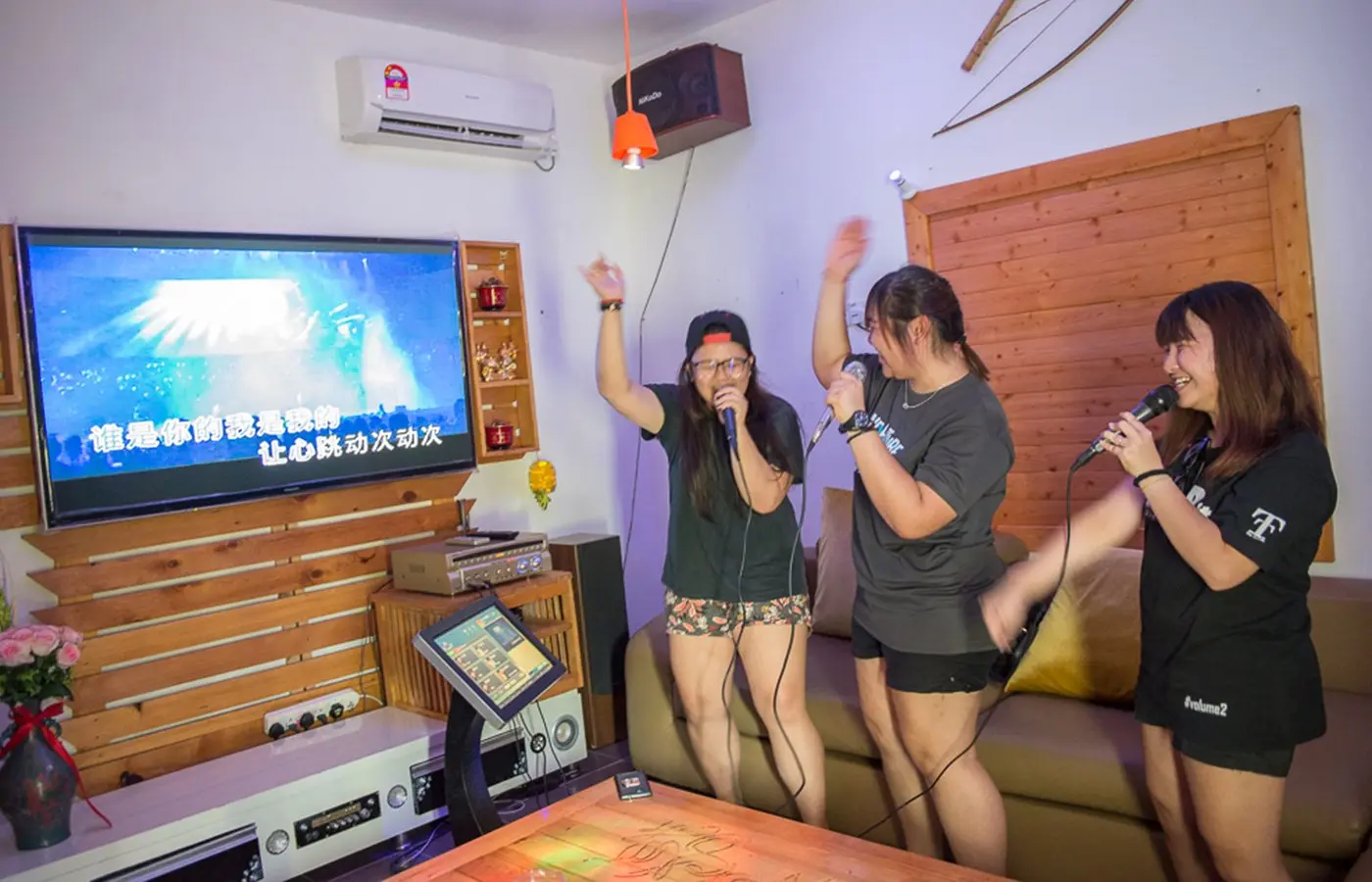 Friends sing together in the private Karaoke Room
